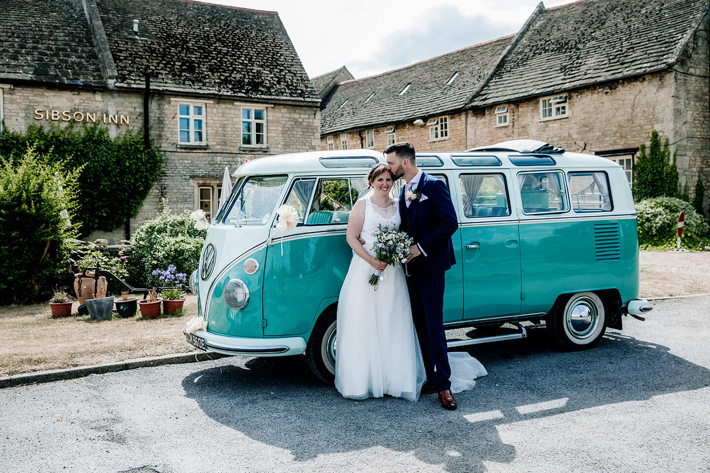 A wedding couple standing outside of the Sibson Inn hotel