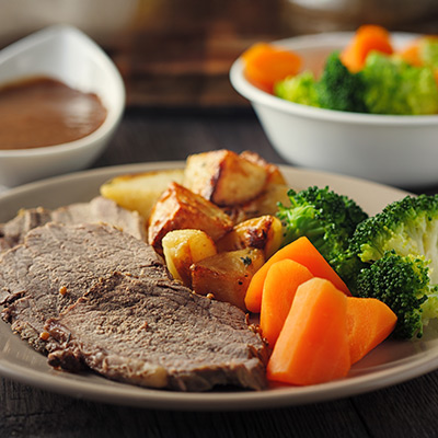 roasted beef with roast potatoes and vegetables